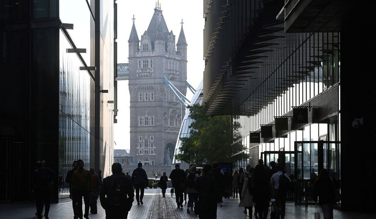 Workers walk towards Tower Bridge